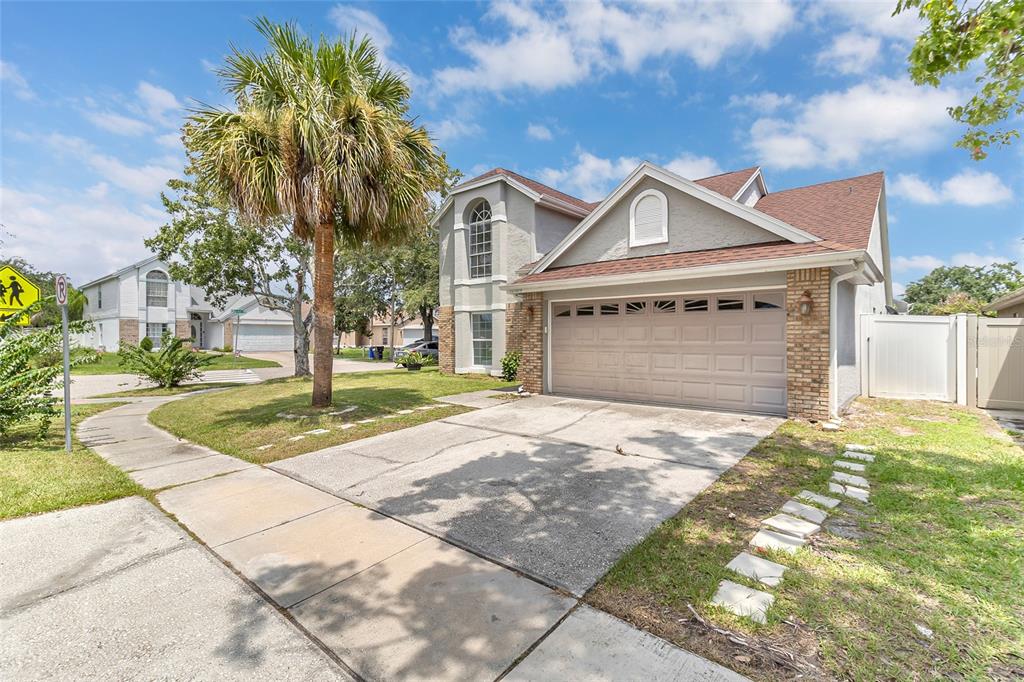 An aerial view shows a residential house with a large backyard highlighted by a red border — 12509 CRAYFORD AVENUE, ORLANDO, FL