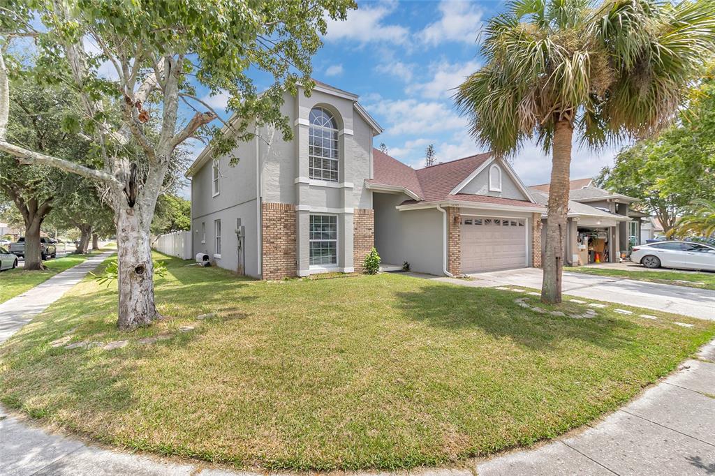 An aerial view shows a two-story house with a brown roof and a fenced backyard — 12509 CRAYFORD AVENUE, ORLANDO, FL