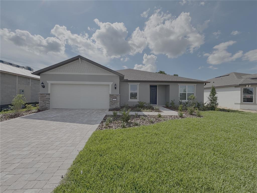 A single-story house with a gray exterior, a two-car garage, and a paved driveway — 6360 SW 82 TERRACE, OCALA, FL