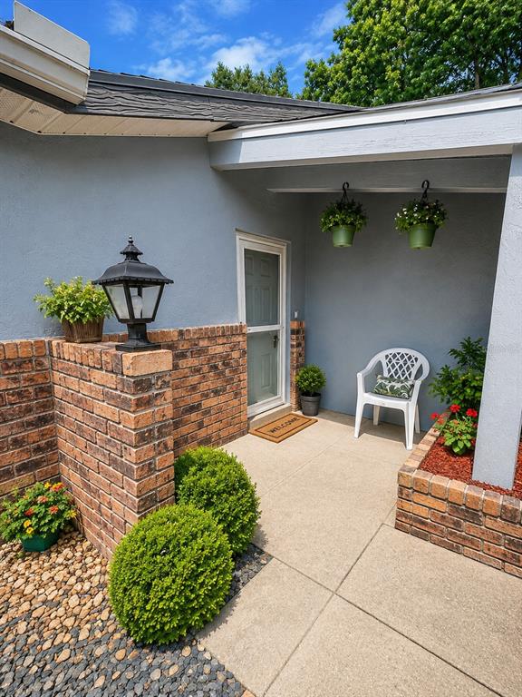 A kitchen features white cabinets, laminate countertops, stainless steel appliances, and patterned vinyl flooring — 3800 E SILVER SPRINGS BOULEVARD UNIT 8, OCALA, FL