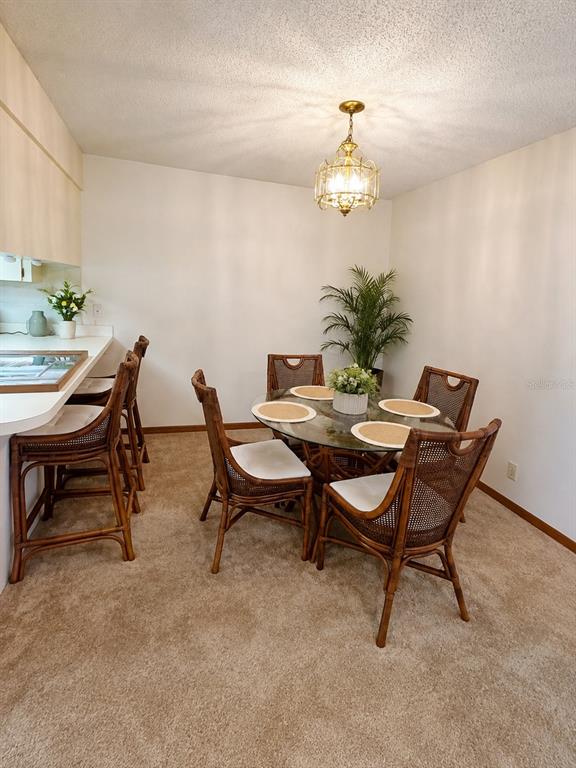 A bathroom features a white vanity, a toilet, and a tiled shower with sliding glass doors — 3800 E SILVER SPRINGS BOULEVARD UNIT 8, OCALA, FL