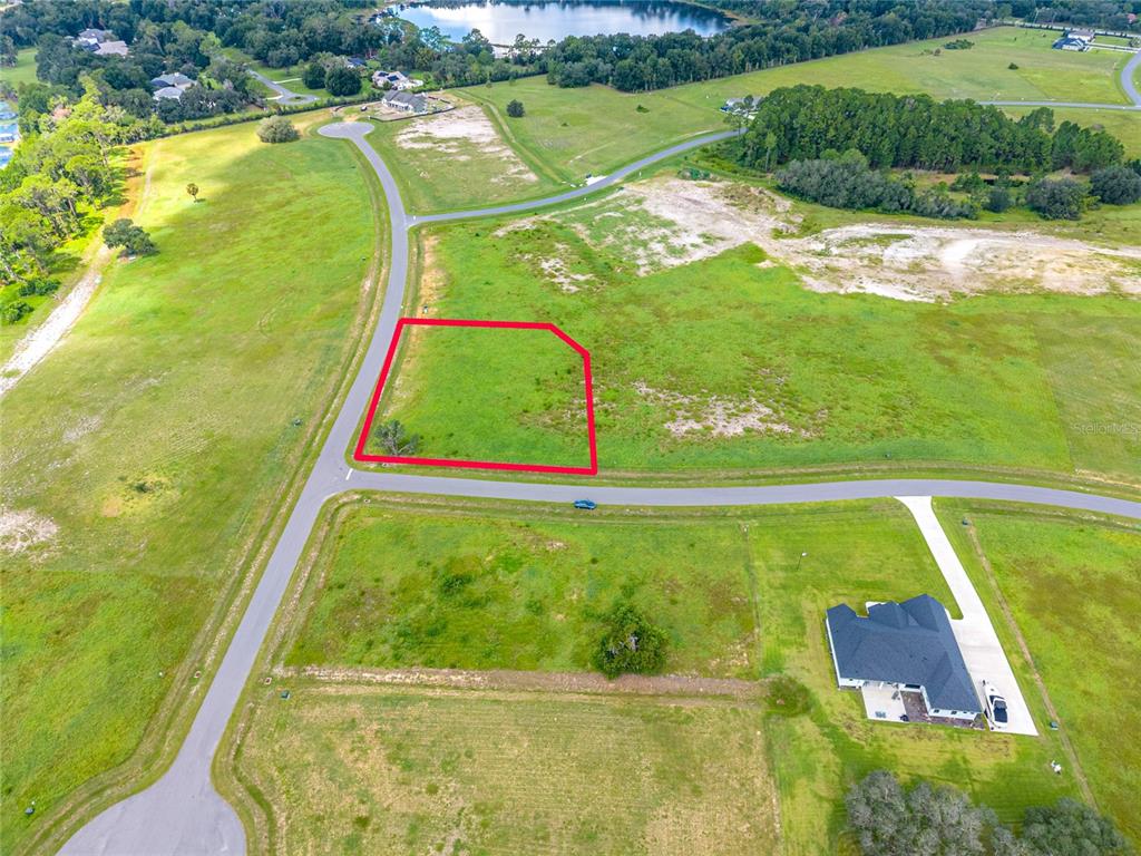 An aerial view shows a vacant residential lot outlined in red within a rural subdivision — 38345 LAKE MEADOW COURT, UMATILLA, FL