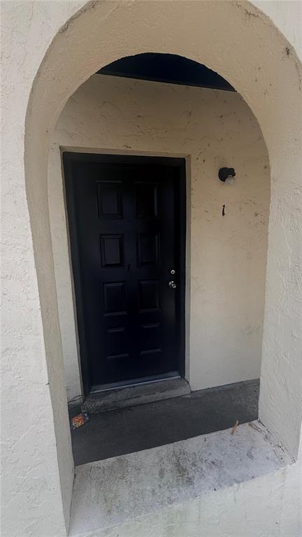 A two-story tan townhouse with a flat roof and a small front porch — 2735 SW 35TH PLACE UNIT 1801, GAINESVILLE, FL
