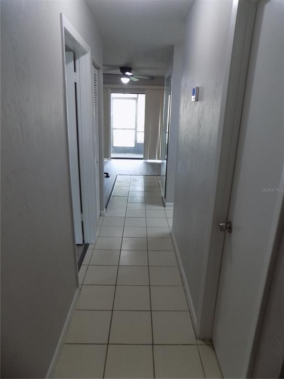 A black front door is set within a recessed arched entryway of a stucco building — 2735 SW 35TH PLACE UNIT 1801, GAINESVILLE, FL