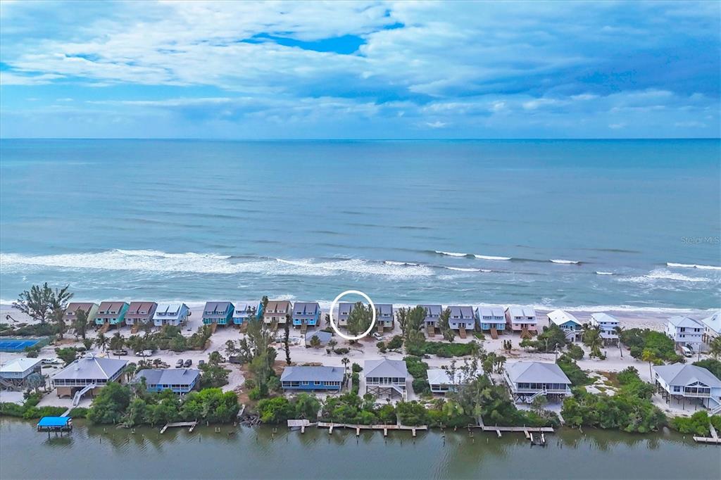 An aerial view shows a row of beach houses along the coast with a circled property — 301 S GULF BOULEVARD UNIT 11, PLACIDA, FL