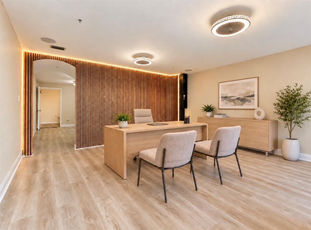 A home office features a round meeting table, two desks, and a green accent wall — 130 S BUMBY AVENUE Unit A, ORLANDO, FL