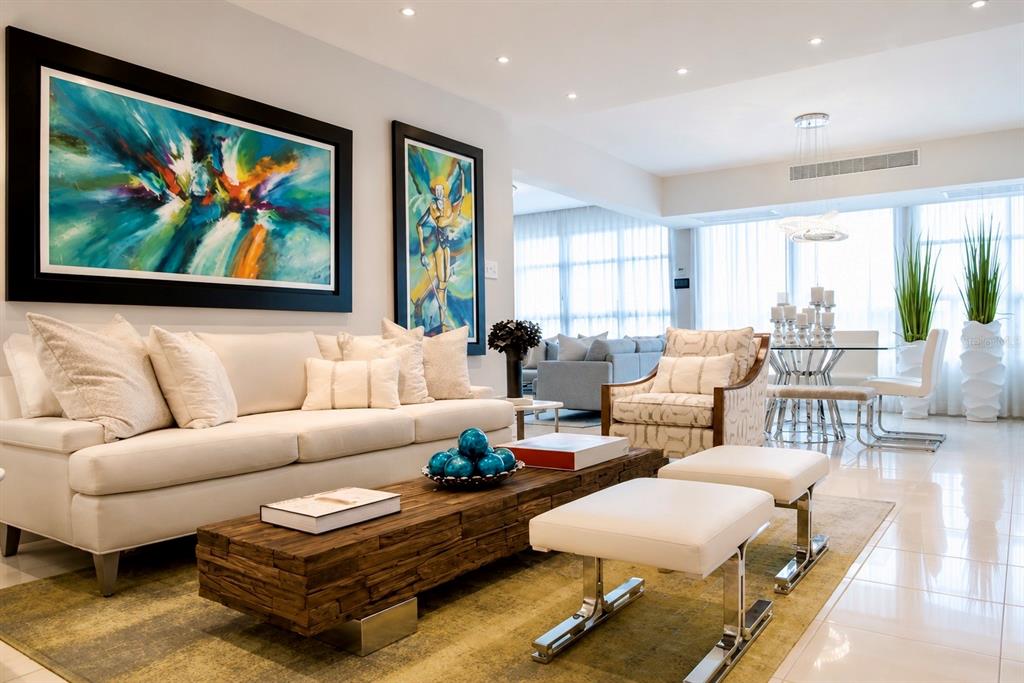 A modern living room features a white sofa, a rustic wooden coffee table, and abstract art — 405 COND. MIRADOR DEL PARQUE UNIT 904, SAN JUAN, PR