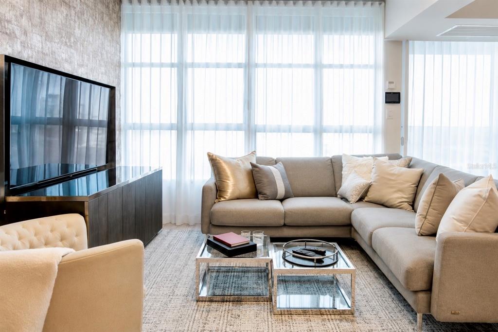 A living room features a grey sectional sofa, a glass coffee table, and a television — 405 COND. MIRADOR DEL PARQUE UNIT 904, SAN JUAN, PR