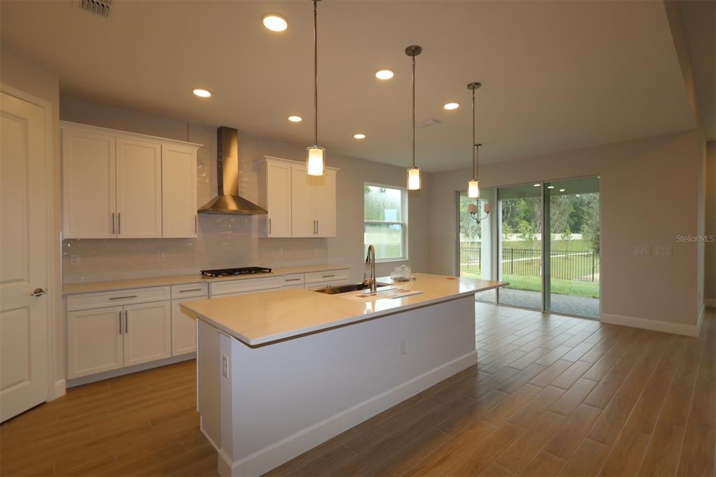 An interior view of a house under construction showing exposed wood framing and roof trusses — 3722 WOLVES CREEK PLACE, APOPKA, FL