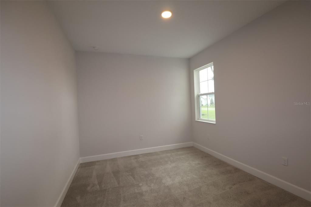 An unfinished interior space features exposed wooden framing, concrete block walls, and open ceiling joists — 3722 WOLVES CREEK PLACE, APOPKA, FL