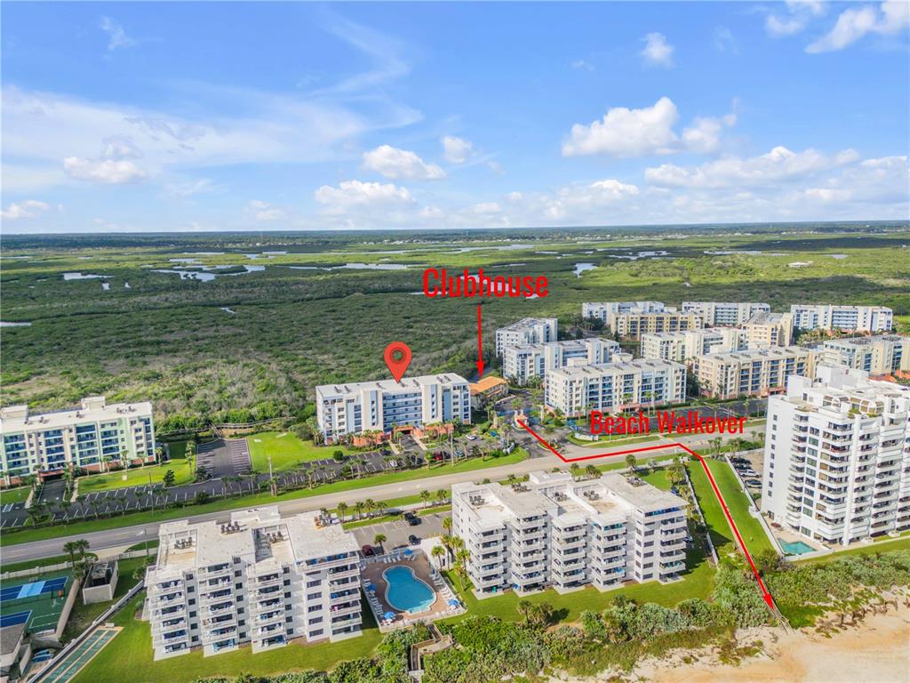 An aerial view of a coastal condominium complex with a pool and beach access — 5300 S ATLANTIC AVENUE UNIT 17-207, NEW SMYRNA BEACH, FL
