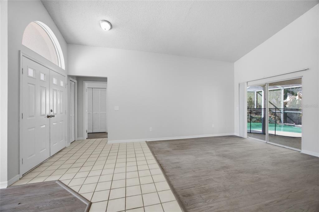 An interior view shows a dining area with wood-look flooring and a tiled transition — 812 CRESTRIDGE DRIVE, TARPON SPRINGS, FL