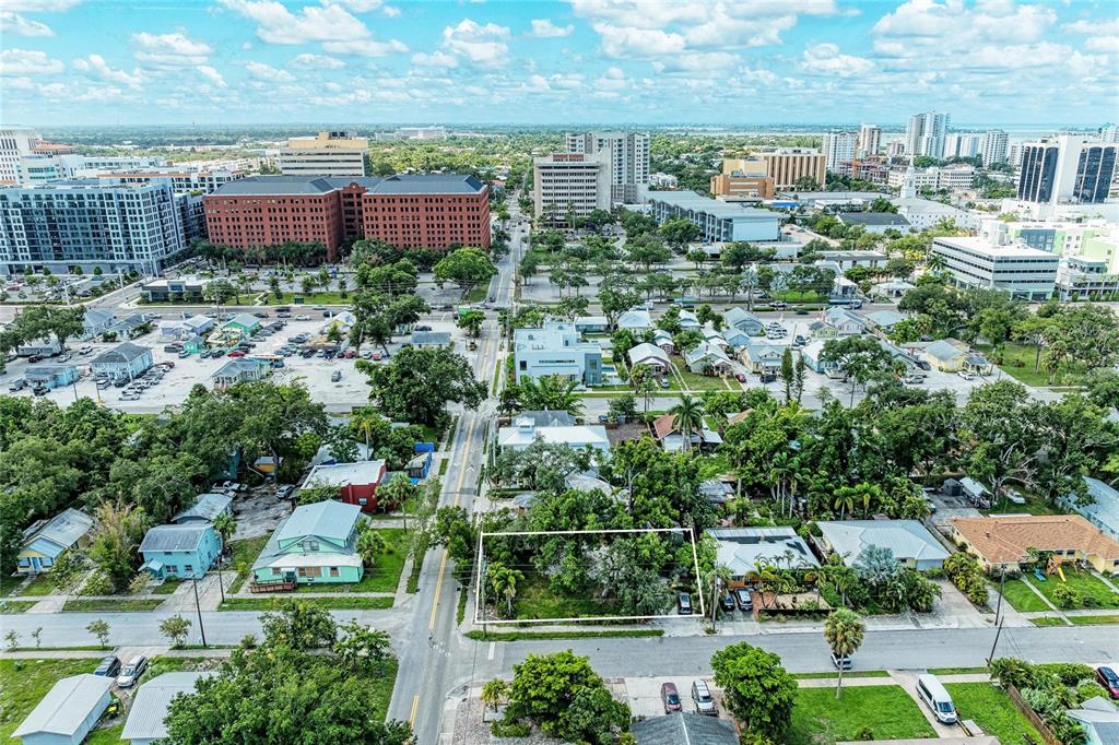 An aerial view shows a vacant rectangular lot surrounded by residential houses and city buildings — 449 N OSPREY AVENUE, SARASOTA, FL