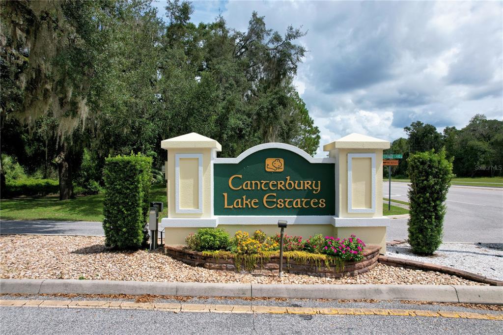 A sign for Canterbury Lake Estates stands in a landscaped bed beside a road — 2856 E CHARTWELL CIRCLE, HERNANDO, FL