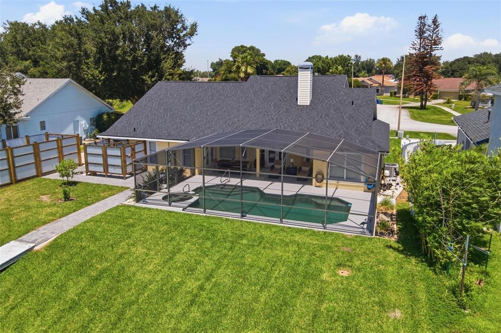 An aerial view of a house with a screened-in pool and a large backyard — 3716 BAYSHORE CIRCLE, TAVARES, FL