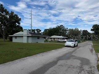 A white car is parked on a paved road in front of two single-story houses — 6632 W PELICAN LANE, HOMOSASSA, FL