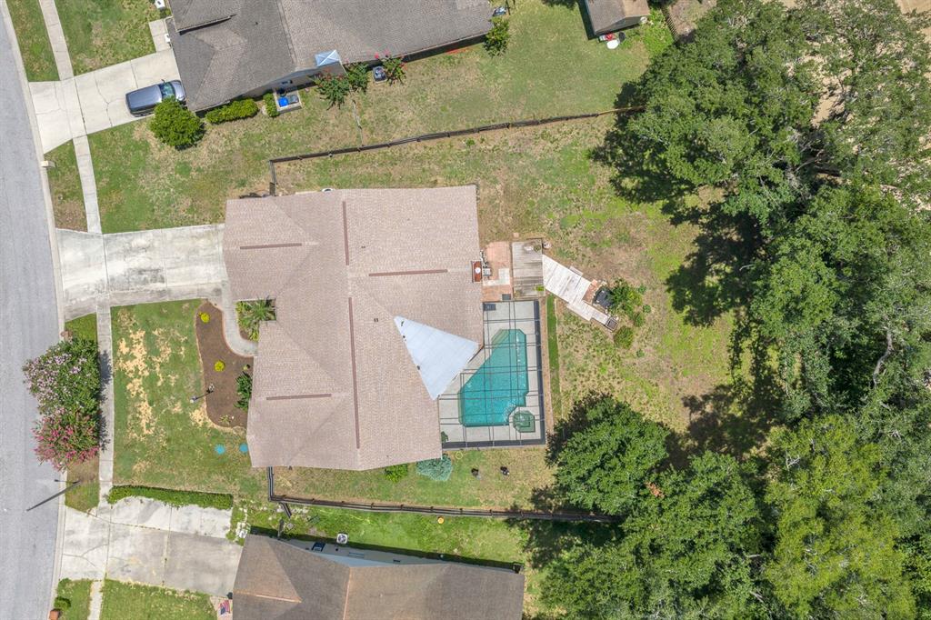 A living room with carpeted floors, blue sofas, a piano, and sliding glass patio doors — 621 PENN NATIONAL ROAD, SEFFNER, FL