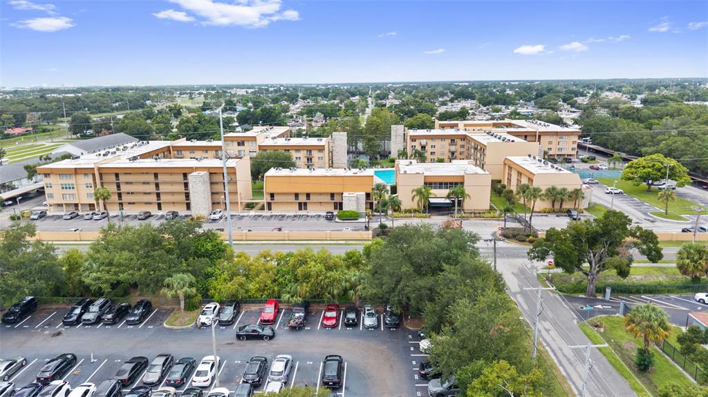 An aerial view shows a multi-story apartment complex with a pool and parking lot — 5820 N CHURCH AVENUE UNIT 345A, TAMPA, FL