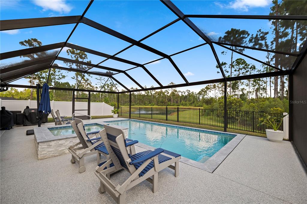 A screened-in pool and spa area features lounge chairs on a concrete patio — 2453 GLADE LANE, GREEN COVE SPRINGS, FL