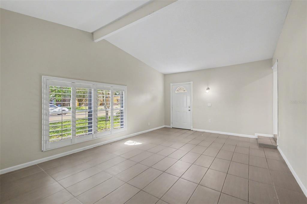 A kitchen with white cabinets, stainless steel appliances, and light-colored tile flooring — 722 GALSWORTHY AVENUE, ORLANDO, FL