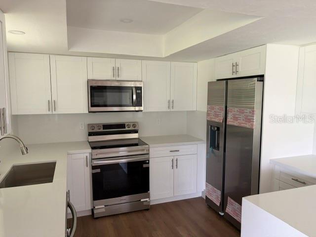 An open-concept living area features light-colored walls, recessed lighting, and wood-look flooring — 8985 SW 196TH TERRACE ROAD, DUNNELLON, FL