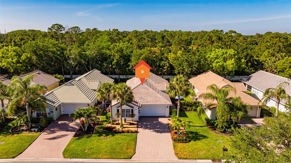 An aerial view shows a suburban house with a tiled roof and a paved driveway — 2305 SUMMERSWEET DRIVE, ALVA, FL