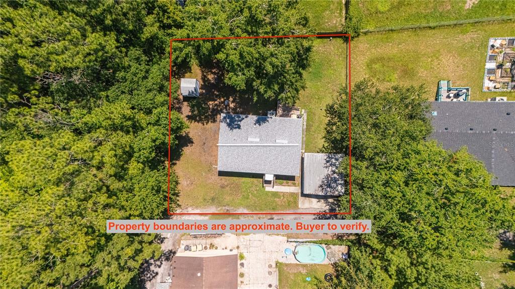 An aerial view shows a house with a carport and shed within a marked lot — 8689 ALEXA LANE, JACKSONVILLE, FL