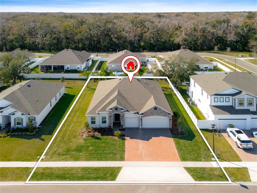 An aerial view shows a single-story suburban house with a brick driveway and fenced yard — 2214 ELEGANT MANOR CIRCLE, EDGEWATER, FL
