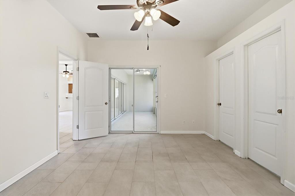 A room with tile flooring, a ceiling fan, and sliding glass doors leading to a patio — 6301 W GLYNBORNE LOOP, CRYSTAL RIVER, FL