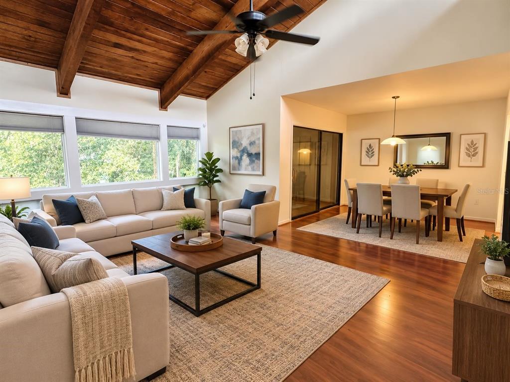 A living and dining area features a vaulted wood-plank ceiling and hardwood floors — 6057 WINDHOVER DRIVE UNIT E-08, ORLANDO, FL