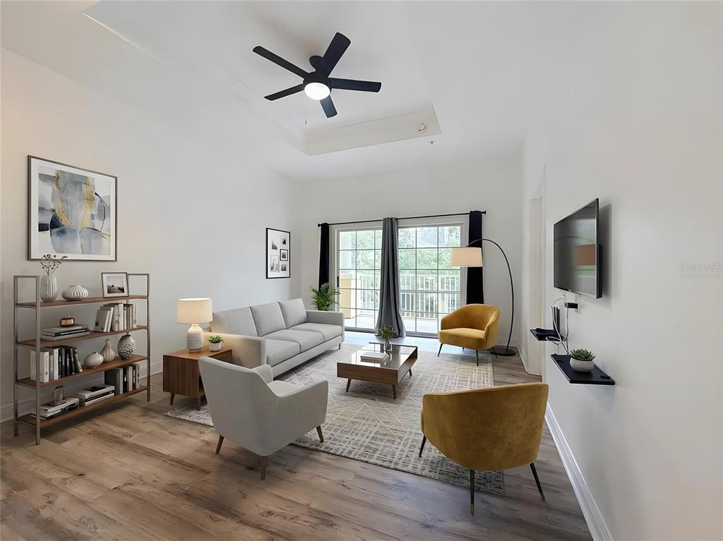 A living room features a light gray sofa, two yellow armchairs, and a ceiling fan — 7510 SEVEN EAGLES WAY, KISSIMMEE, FL