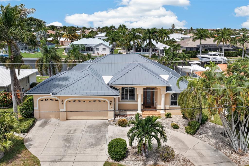 An aerial view of a single-story house with a metal roof and a concrete driveway — 959 BAL HARBOR BOULEVARD, PUNTA GORDA, FL
