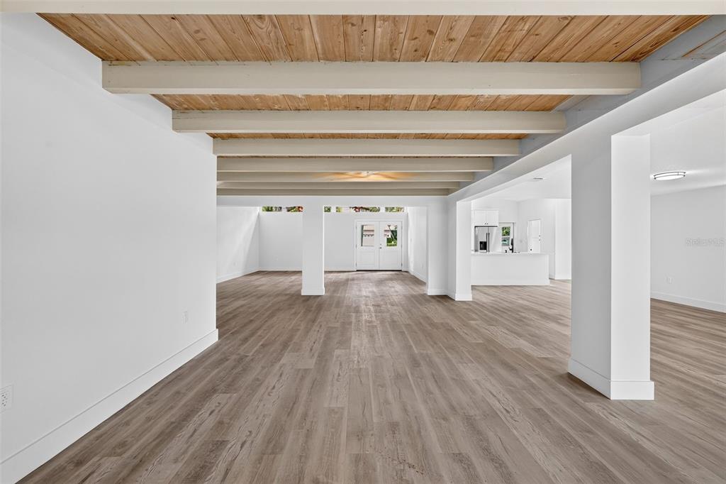 A white house exterior features a large open carport with a concrete driveway and lawn — 341 SHORE DRIVE, ELLENTON, FL