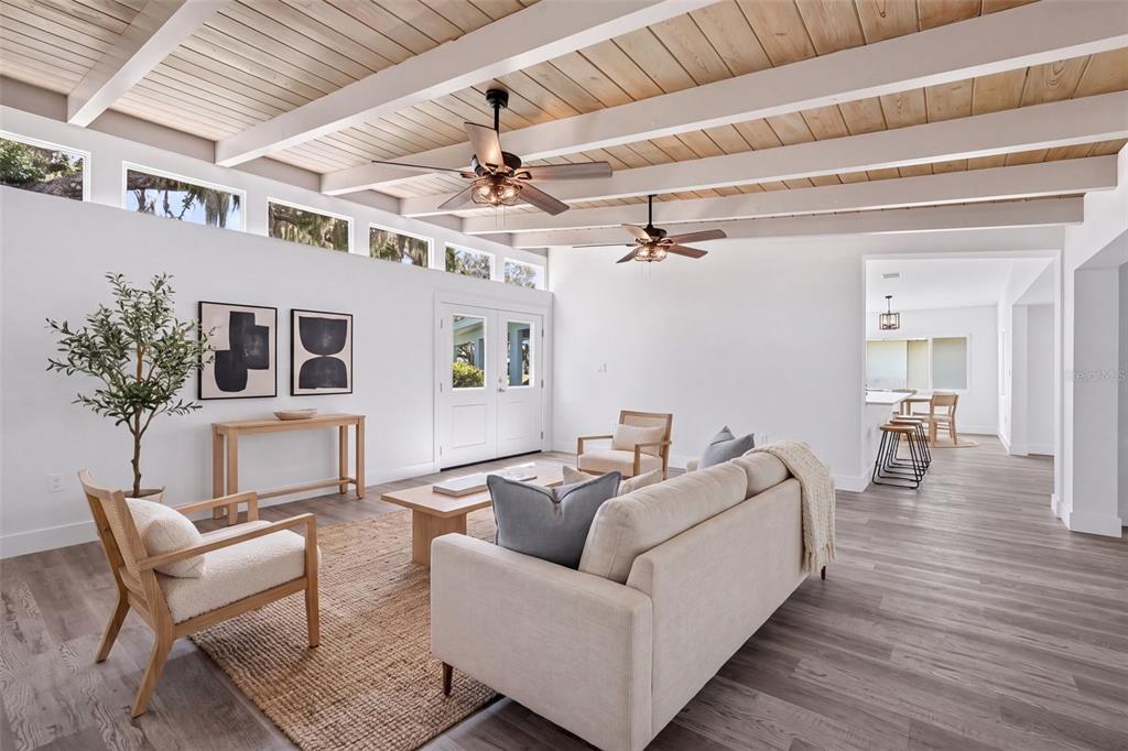 A single-story house with a carport and a large oak tree under a sunset sky — 341 SHORE DRIVE, ELLENTON, FL
