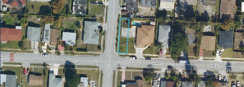 This aerial map shows a residential property lot highlighted in blue near a street intersection — W 6TH STREET, RIVIERA BEACH, FL