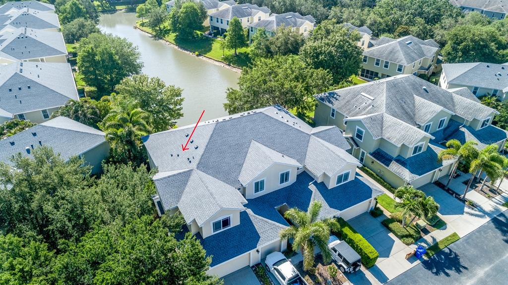A beige two-story house features a two-car garage and a white pickup truck parked outside — 403 HARBOR RIDGE DRIVE, PALM HARBOR, FL