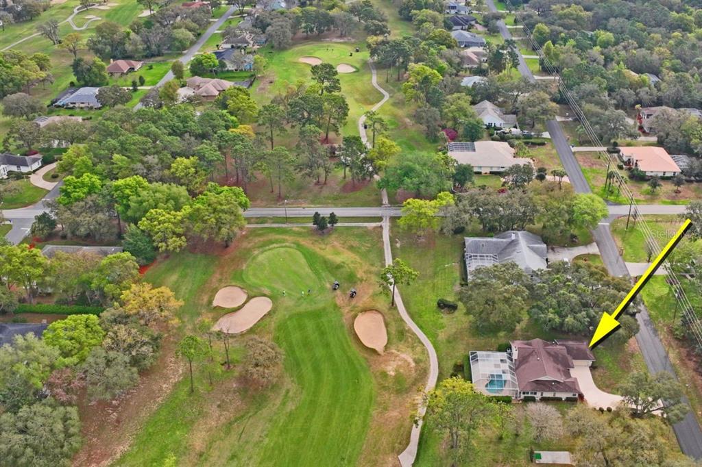 An aerial view shows a house with a pool located next to a golf course — 375 E LIBERTY STREET, HERNANDO, FL