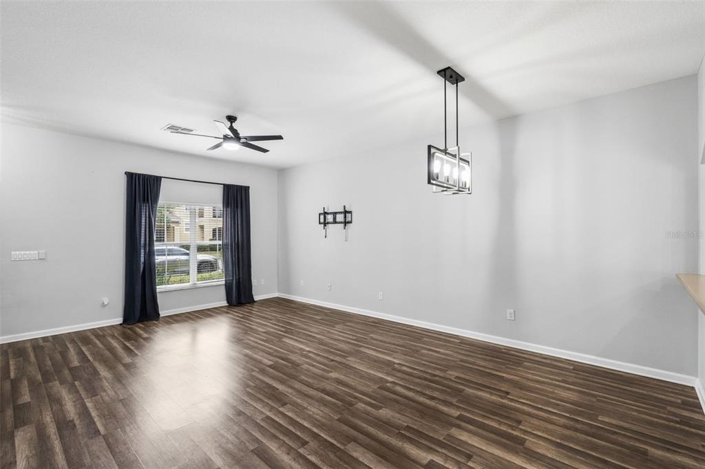 The exterior of a two-story townhouse features a blue door, shutters, and a brick walkway — 11843 DEER PATH WAY, ORLANDO, FL