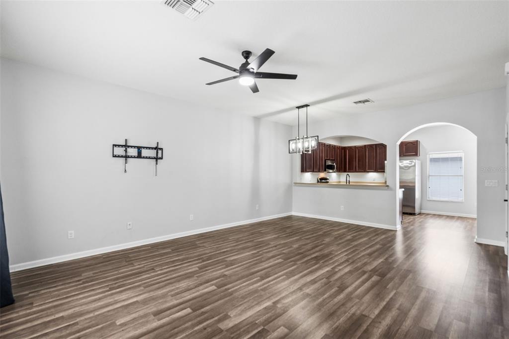 A two-story townhouse exterior features blue and beige stucco walls with blue shutters — 11843 DEER PATH WAY, ORLANDO, FL
