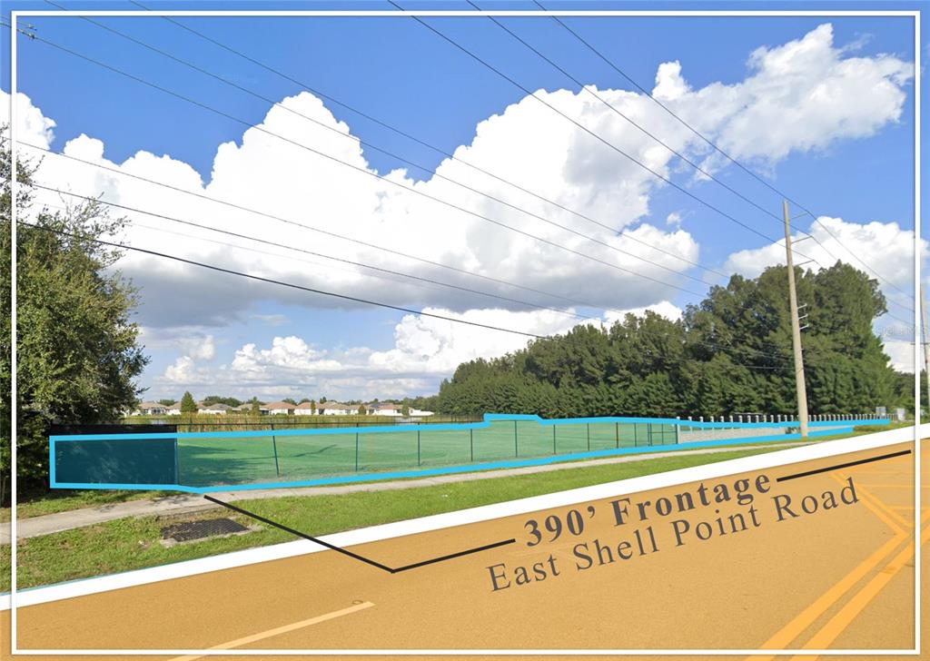 A fenced, grassy lot sits adjacent to a paved road under a cloudy sky — 962 E SHELL POINTE ROAD, RUSKIN, FL