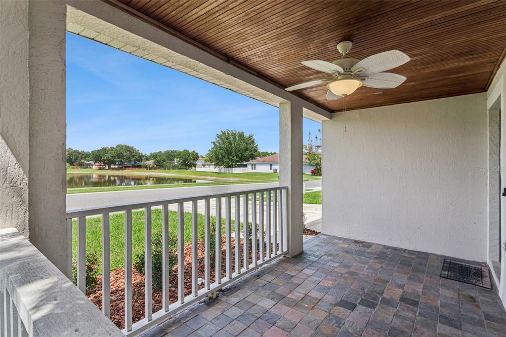 A covered porch features a wood-paneled ceiling, a ceiling fan, and a tiled floor — 3308 ERSKINE DRIVE, ORLANDO, FL
