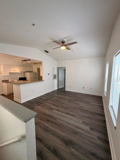 An open-concept living area features wood-look flooring, a ceiling fan, and an adjacent kitchen — 877 GRAND REGENCY POINT UNIT 200, ALTAMONTE SPRINGS, FL