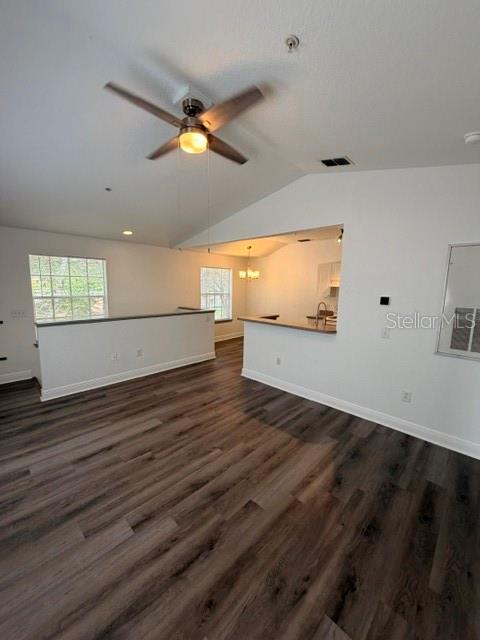 An open-concept living area features wood-look flooring, a vaulted ceiling with a fan, and a kitchen — 877 GRAND REGENCY POINT UNIT 200, ALTAMONTE SPRINGS, FL