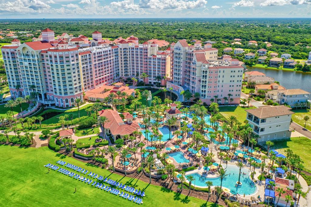 An aerial view of a large resort complex featuring multiple pools and surrounding residential buildings — 200 OCEAN CREST DRIVE UNIT 1018, PALM COAST, FL