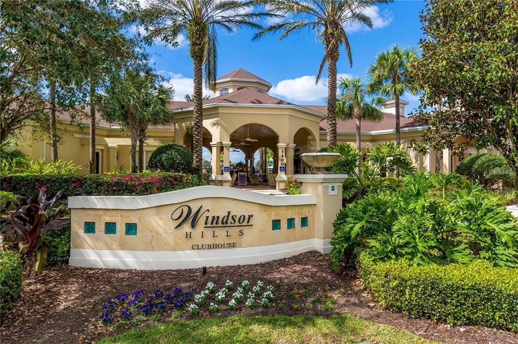 A sign for the Windsor Hills clubhouse stands in front of a large beige building — 2817 ALMATON LOOP UNIT 304, KISSIMMEE, FL