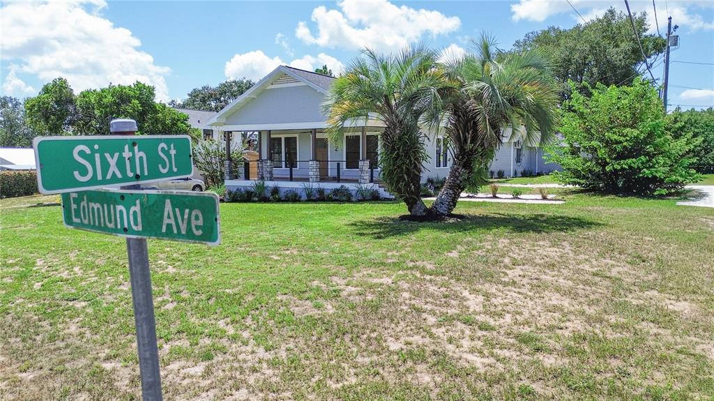 A single-story house with a front porch stands behind a street sign at an intersection — 602 EDMUND AVENUE, DUNDEE, FL