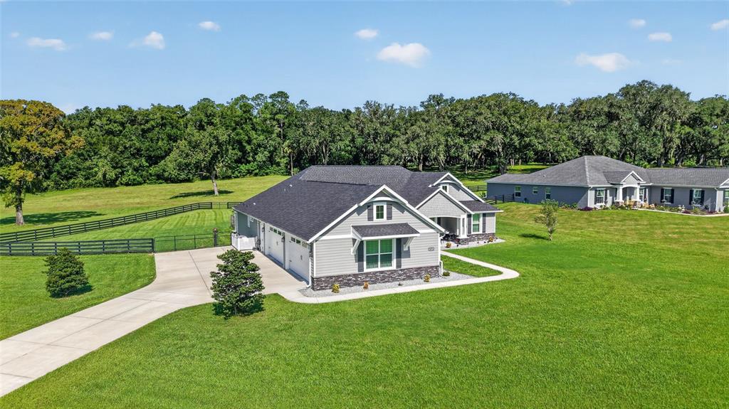 An aerial view shows a gray suburban house with a garage and a large lawn — 1971 NW 86TH PLACE, OCALA, FL