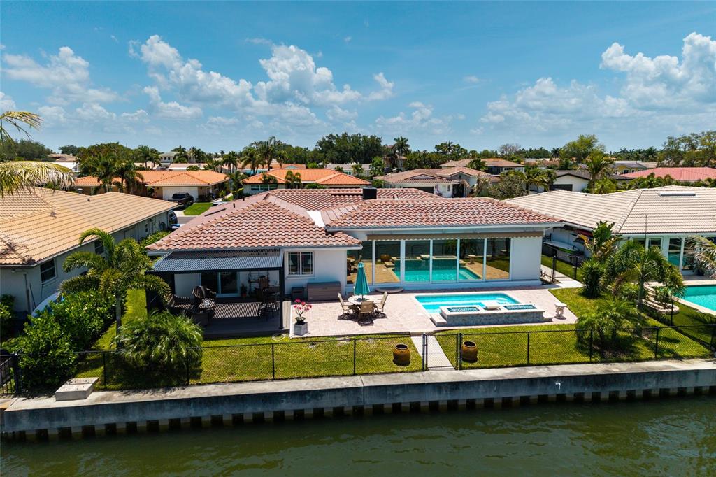A single-story house with a tiled roof, a light green garage door, and a paved driveway — 2011 MICHIGAN AVENUE NE, ST PETERSBURG, FL