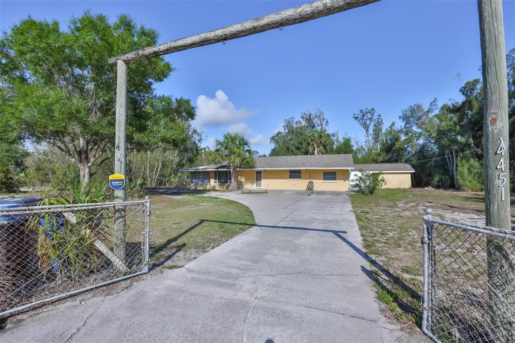 An aerial view shows a rectangular property outlined in red containing trees and structures — 14451 HIGHLAND ROAD, WIMAUMA, FL