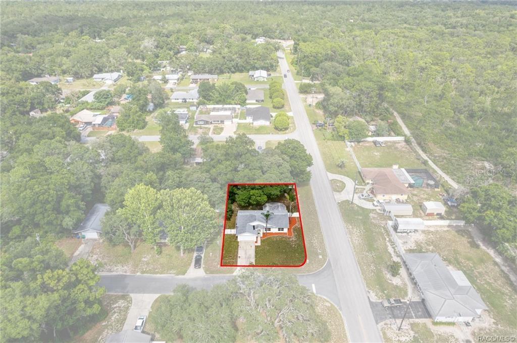 An aerial view shows a single-story house outlined in red on a corner lot — 1014 STETSON TERRACE, INVERNESS, FL